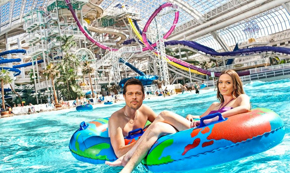 Brad Pitt and Angelina Jolie's faces are photoshopped on a man and woman's bodies. The man and woman are floating in West Edmonton Mall's wave pool.