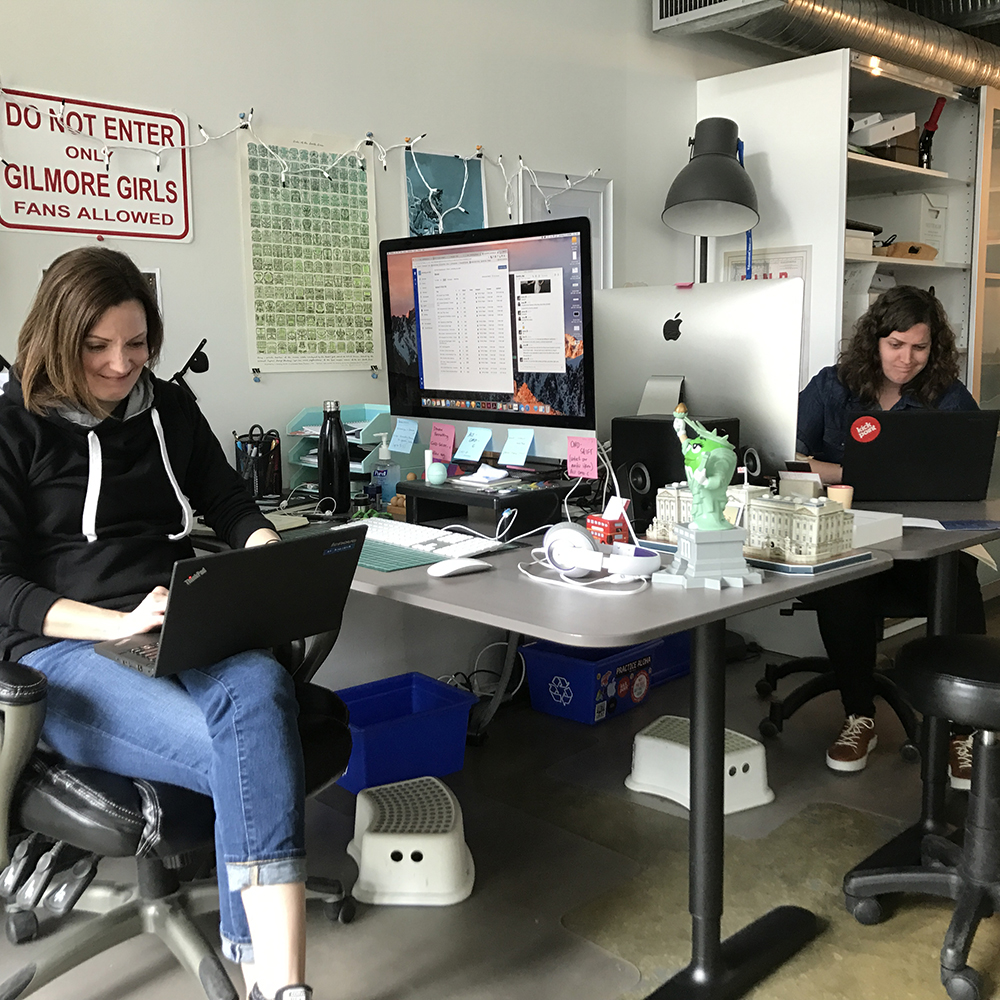 Emma Butler and Sarah Gardener working at Kick Point — using PCs for the first time in years