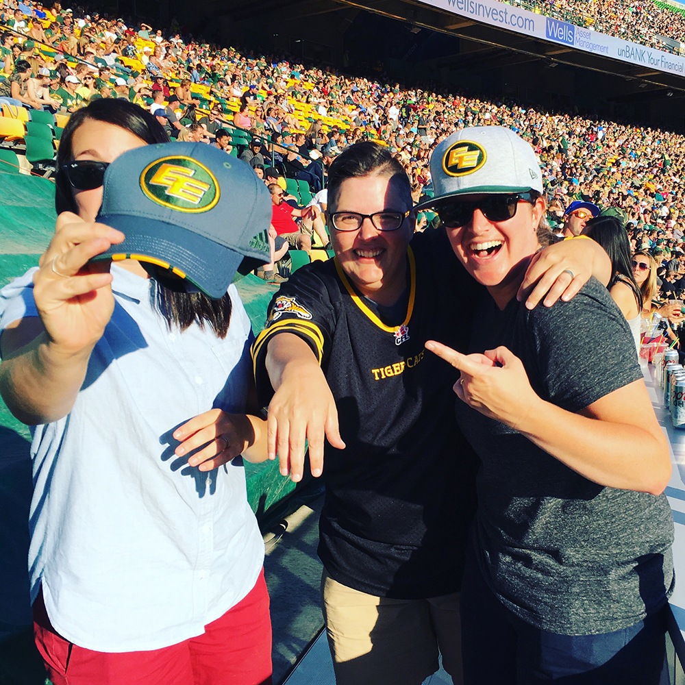 Dana DiTomaso, Jen Salamandick, and Emma Butler arguing about the Edmonton CFL team vs the Hamilton Tiger Cats