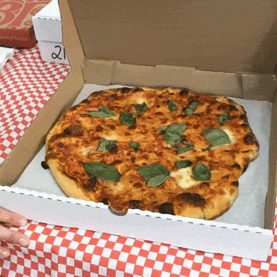 Leva pizza box opening to display a margherita pizza