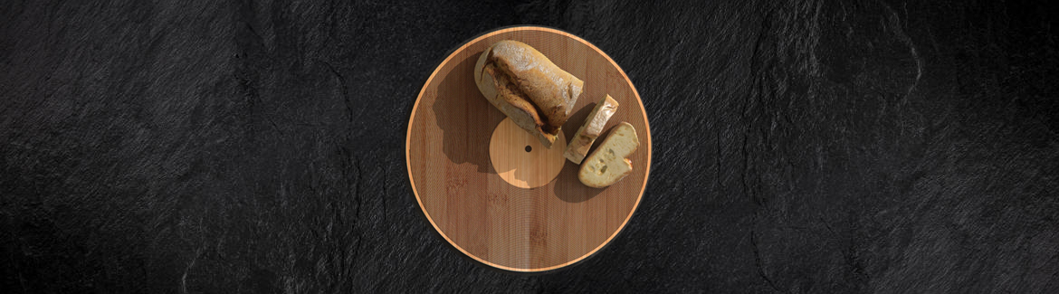 Sliced baguette on a circular cutting board. The cutting board looks like a vinyl record.