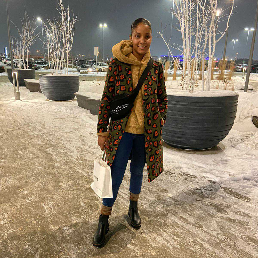 Firdous poses in mall parking lot in winter