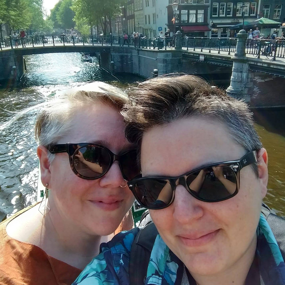 Dana and her wife Ashley in front of a canal