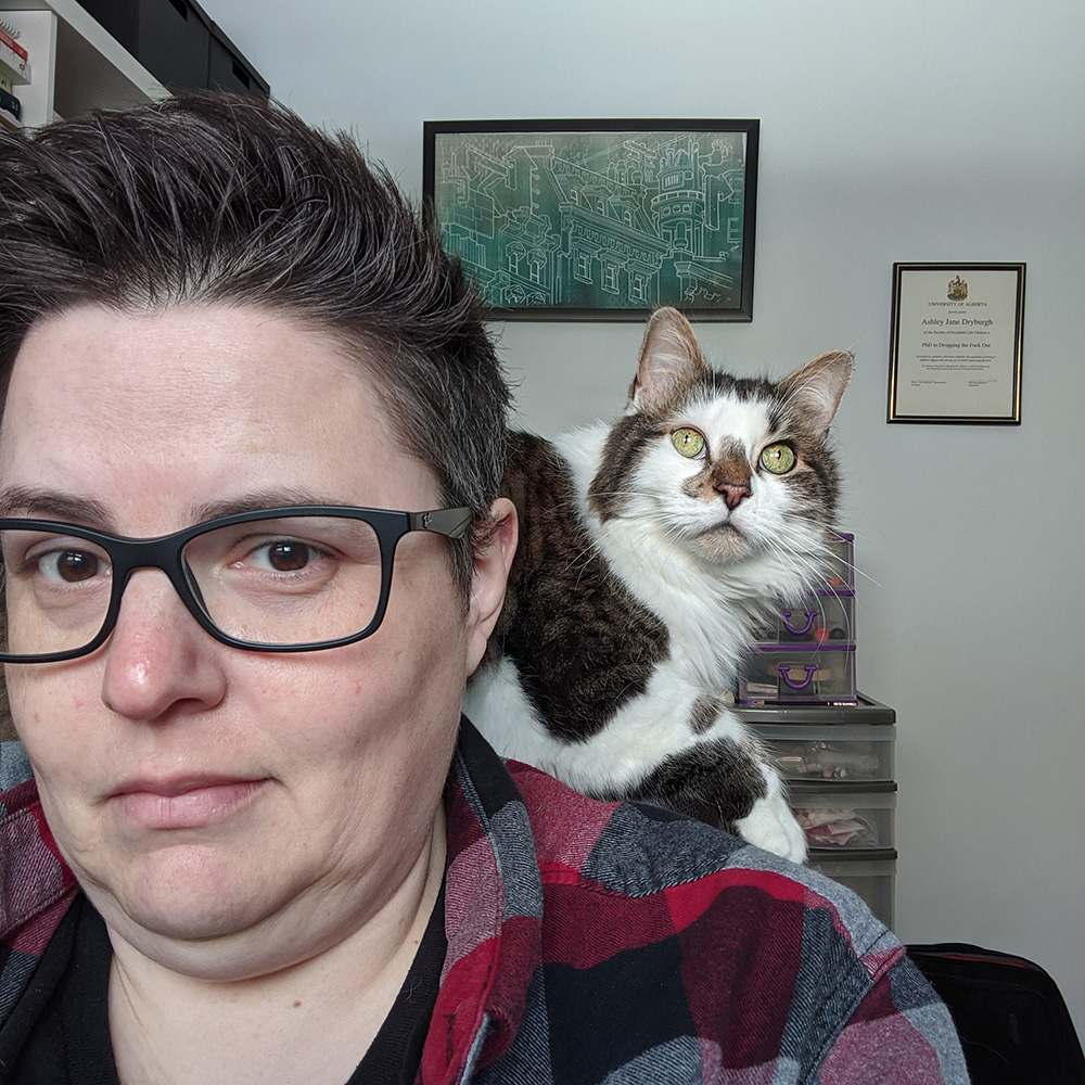 A cat sits on Dana's shoulder