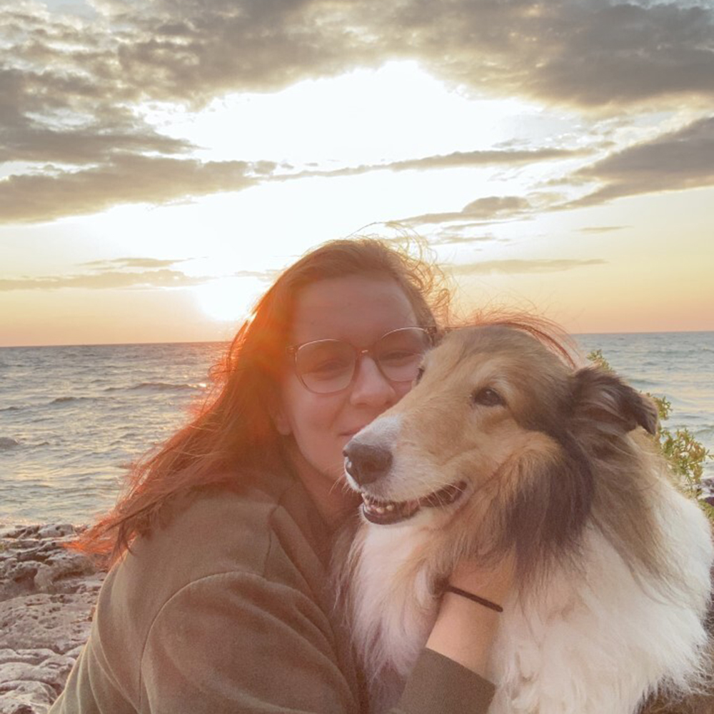 Jaime snuggles her dog as the sunsets